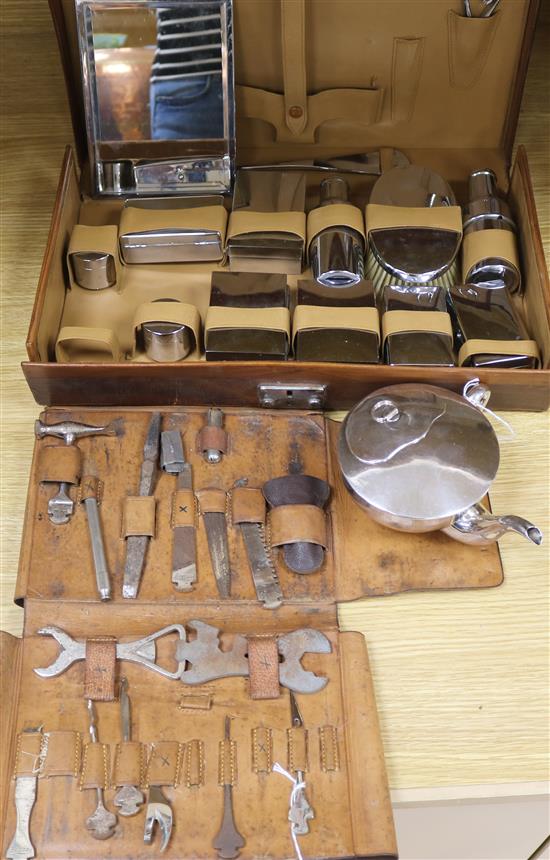 A leather-cased Bonsa tool kit, a leather dressing case containing various plate-mounted fitments and a plated invalid cup